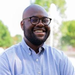 Aaron_Guerrier - man smiling wearing glasses and light blue dress shirt